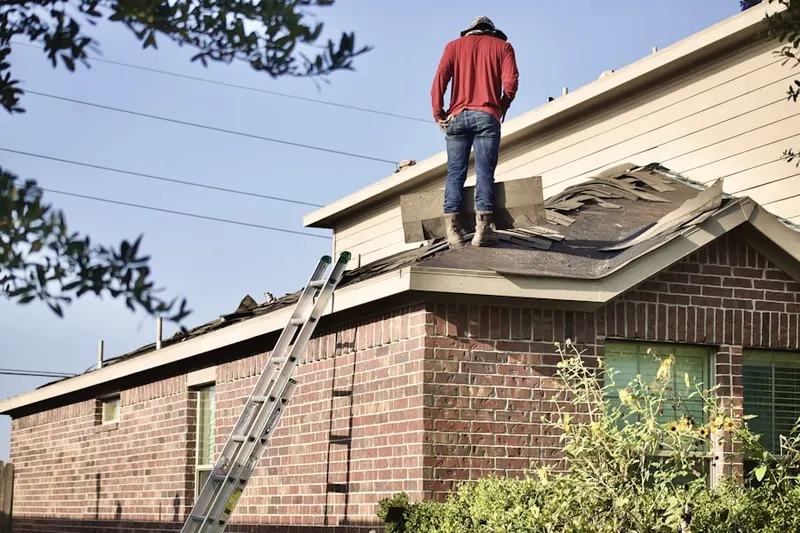 Professional roofer working on a residential roof in Villa Maria Infirmary